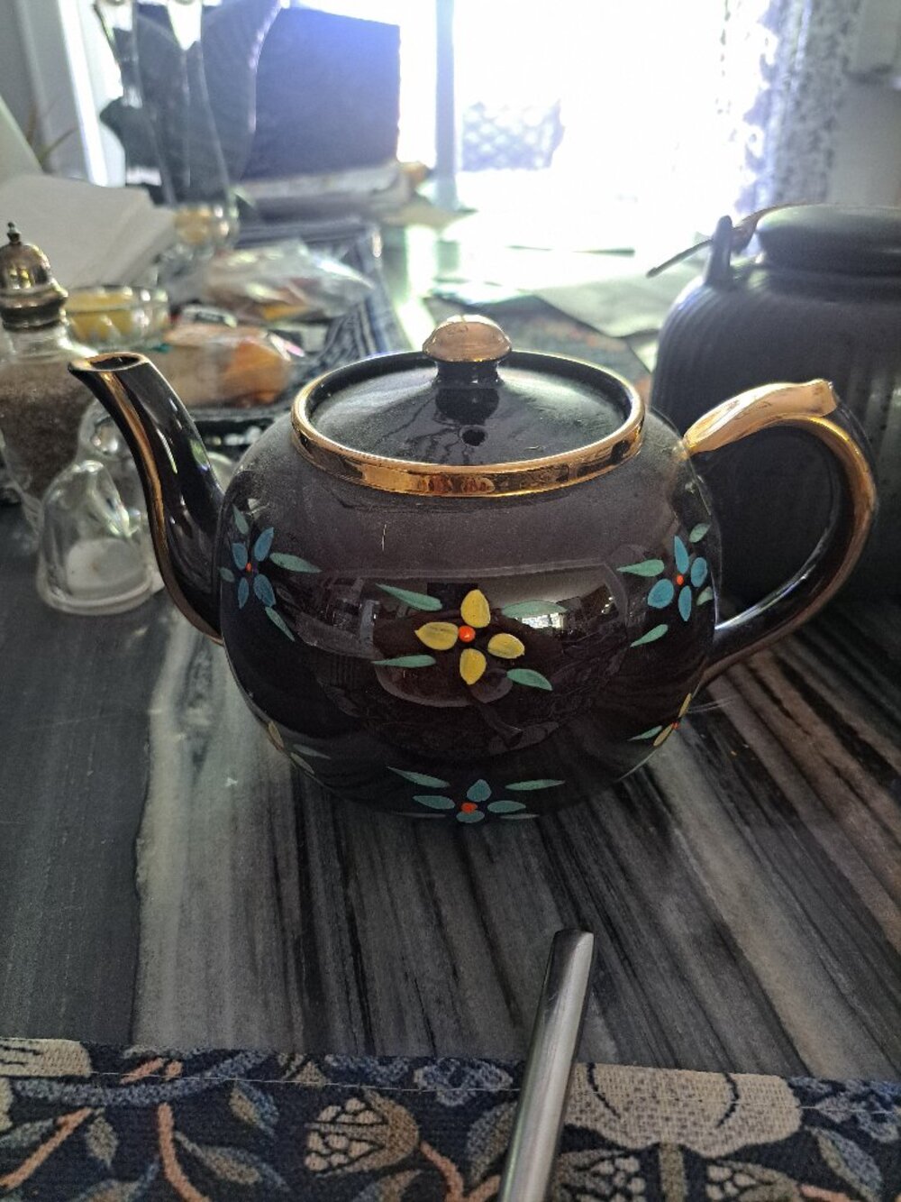 This is a vintage Sadler England teapot in a dark brown glaze, often referred to